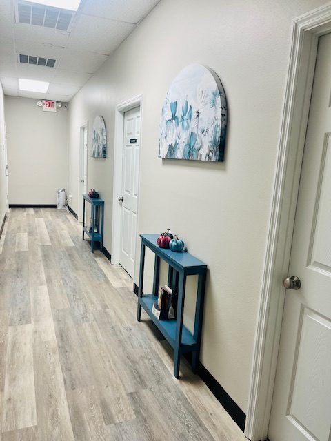 Ellenton hallway with teal accent tables